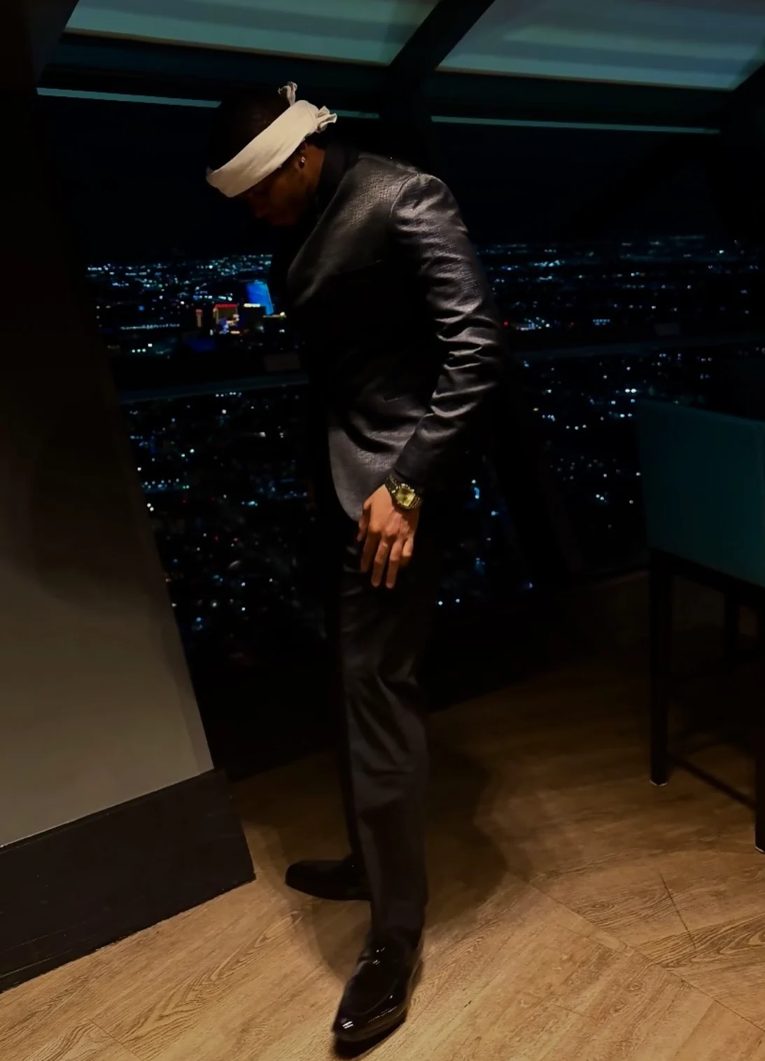 Ant CEO in a suit overlooking the city at night